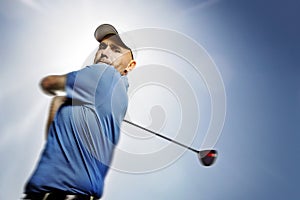 Golfer shooting a golf ball