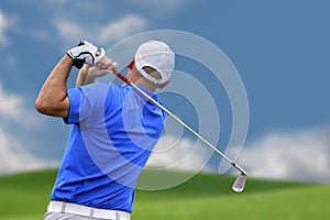 Golfer shooting a golf ball