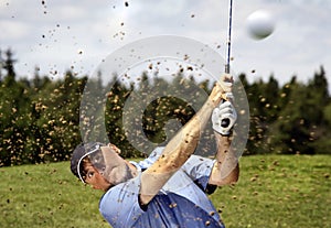 Golfer shooting a golf ball