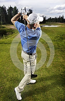 Golfer shooting a golf ball