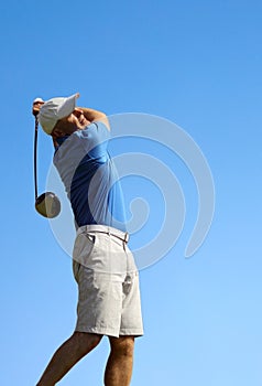 Golfer shooting a golf ball