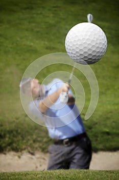 Golfer shooting a golf ball