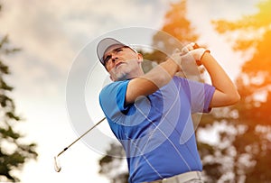 Golfer shooting a golf ball