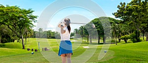 Golfer sport course golf ball fairway. People lifestyle woman playing game golf tee of blue sky background.