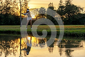 Golfer sport course golf ball fairway. People lifestyle woman playing game golf tee of on the green grass sunset background.