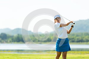 Golfer sport course golf ball fairway. People lifestyle woman playing game golf tee off on the green grass