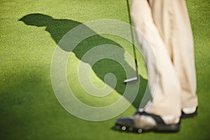 Golfer stood on green photo
