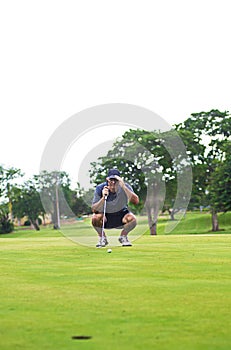 Golfer studies green for putt