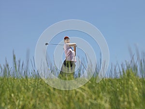 Golfer Swinging A Golf Club