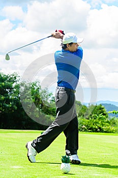 Golfer swinging his gear and hit the golf ball