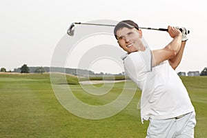 Golfer swinging his niblick out