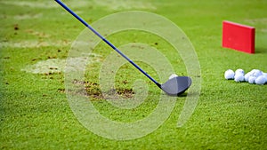 Golfer tee off golf ball before swing.