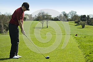 Golfer teeing off