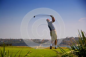 Golfer teeing off