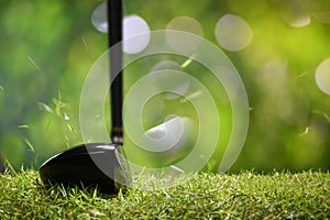 Golfer teeing off golf ball from tee