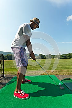 Golfer Teeing Up at the Driving Range