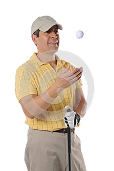 Golfer tossing a ball