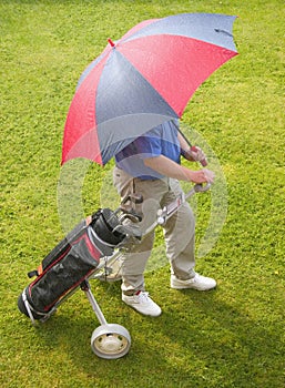 Golfer and umbrella