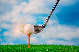 Golfer use golf club hitting golf ball on tee off zone