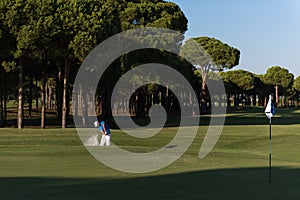 Golfer walking and carrying golf bag