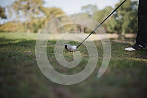 Golfers asia man show hit sweeping at green lawn. Low angle view