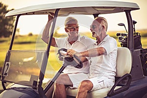 Golfers couple are riding in a golf cart