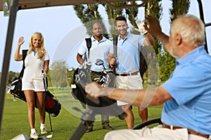 Golfers greeting on golf course