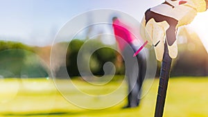 Golfers Hand and Glove leaning on a golf club