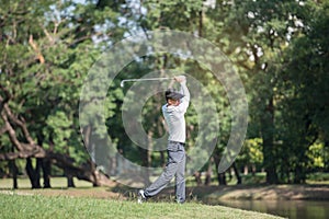 Golfers man show hit sweeping at green lawn
