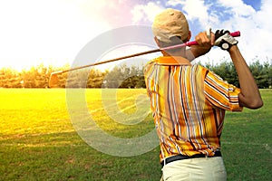 Golfers men player golf hit swing shot on course in sunrise.