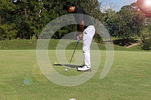 Golfers are playing golf in the evening golf course