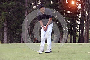 Golfers are playing golf in the evening golf course