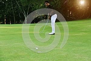 Golfers are playing golf in the evening golf course