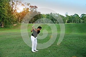 Golfers are playing golf in the evening golf course