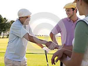 Golfers Shaking Hands On Golf Course