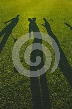 Golfers silhouette on grass