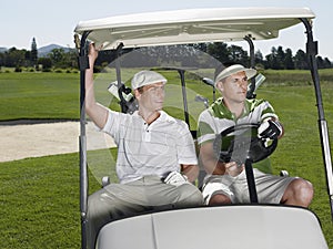 Golfers Sitting In Golf Cart