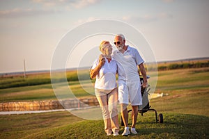 Golfers talking and walking on golf course