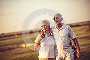 Golfers talking and walking on golf course