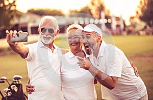 Golfers using phone and taking self portrait