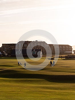 Golfers walking across the beautiful and legendary Old Course at St Andrews in Scotland