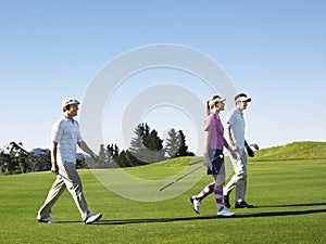 Golfers Walking On Golf Course