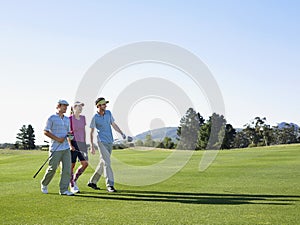 Golfers Walking On Golf Course