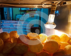 Golgappa chaat fuchka in glass box kept crisp by light bulb heat