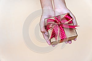 Gollden gift box with red ribbow , giving gift box for special person on special day