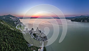 Golubac fortress castle walls standing on Danube river bank in  sunset rays aerial panorama, Serbia