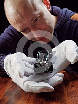 GOMEL, BELARUS - February 16, 2021: portrait of a collector of retro car models on a black background