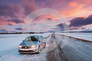 Volkswagen Polo Car Sedan Parking On A Roadside Of Country Road On A Background Of Dramatic Sunset Sky At Winter Season
