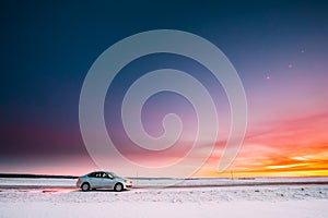 Volkswagen Polo Car Sedan Parking On A Roadside Of Country Road On A Background Of Dramatic Sunset Sky At Winter Season