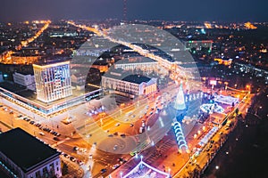 Gomel, Belarus. Main Christmas Tree And Festive Illumination On Lenin Square In Homel. New Year In Belarus. Aerial Night photo